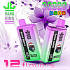 Two Bang King DelphiTech disposable vape devices in pink and green gradient colors with a gorilla wearing a Santa hat on each, positioned against a purple floral background with text highlighting 3000 puffs and 12 flavors.