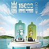 Two Bang King vape devices with cartoon ape designs, one blue and one green, displayed on a white round pedestal by a lake with a partly cloudy sky in the background