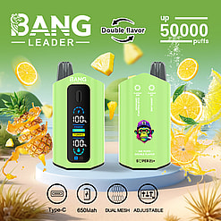 Two green BANG LEADER vaping devices with digital display, surrounded by splashing pineapple and lemon slices on a green background, highlighting double flavor and up to 50,000 puffs, with icons for Type-C charging, 650mAh battery, dual mesh, and adjustable settings.