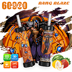 Two Bang Blaze disposable vape devices with colorful cosmic and fantasy-themed design, labeled with watermelon and strawberry melon flavor, displayed against a vibrant background featuring a mystical female figure with blue eyes and ornate costume, surrounded by fruit visuals including watermelon, strawberry, and melon, along with icon indicators of 6 puffs, type-C charging, 1000mAh battery, 40ml capacity, and 0.6 ohm mesh coil.