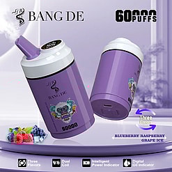 Two purple disposable vape devices with a gorilla face logo and the brand name BANG DE, emitting vapor, placed on a light purple surface with blueberries, raspberries, and ice beside them, highlighted features include 60,000 puffs, three flavors (blueberry, raspberry, grape ice), dual coil, intelligent power indicator, and digital oil indicator.