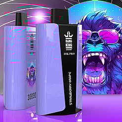 Two lavender-colored disposable vape devices displaying the brand Bang King, model 30K Pro, and flavor Strawberry Grape, with a vibrant illustration of a roaring gorilla wearing pink sunglasses in the background.