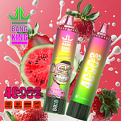 Two Bang King disposable vape devices with strawberry watermelon flavor featuring a cartoon monkey with a halo, surrounded by splashes of milk, whole and sliced strawberries, and a slice of watermelon on a pink gradient background, advertising 40000 puffs and specifications including Type-C, 1000mAh battery, and 1.0 ohm mesh coil.