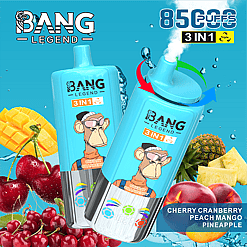 Two blue Bang Legend 3-in-1 disposable vaping devices with a monkey graphic and cherry cranberry flavor, surrounded by fresh mango, cherries, cranberry, pineapple, and peach against a blue background with text indicating 8500 puffs and fruit flavors.