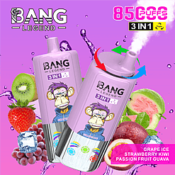 Two purple BANG LEGEND 3 IN 1 disposable vape devices featuring a cartoon monkey wearing sunglasses and a hoodie, surrounded by images of grape, kiwi, strawberry, passion fruit, guava, and ice cubes, with text highlighting 8500 puffs and flavor flavors grape ice, strawberry kiwi, and passion fruit guava.