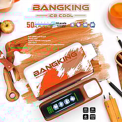 Two BangKing ice cool vape devices on a wooden surface surrounded by an apple, a glass of orange liquid, pencils, and cartoon-style icons showing 50K puffs, 5 levels of adjustable coolness, 850mAh battery, and 25ml e-liquid capacity.