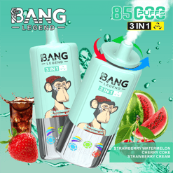 Deux dispositifs de vape jetables verts à la menthe étiquetés Bang Legend 3 en 1 avec une image d'un singe portant un chapeau rouge, mettant en évidence des saveurs de pastèque de fraise, du coke cerise et de la crème de fraise, entouré de touches d'eau, d'une fraise, d'un verre de cola, de cerises et de tranches de talon