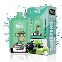 Green Bang Box vape device with a digital display featuring a cartoon monkey wearing sunglasses and a halo, next to its packaging box labeled Raspberry Sour Apple and 15000 puffs, surrounded by water splashes, blackberries, green apples, and apple blossoms.