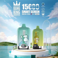 Two Bang King vape devices with cartoon ape designs, one blue and one green, displayed on a white round pedestal by a lake with a partly cloudy sky in the background