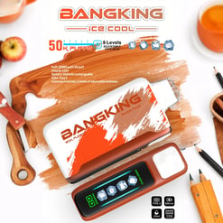 Two BangKing ice cool vape devices on a wooden surface surrounded by an apple, a glass of orange liquid, pencils, and cartoon-style icons showing 50K puffs, 5 levels of adjustable coolness, 850mAh battery, and 25ml e-liquid capacity.