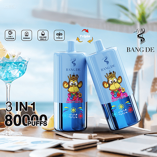 Two blue BANG DE vape devices with a cartoon monkey wearing a crown and pink jacket, displayed on a table with a beach background, alongside a blue cocktail glass and text highlighting 3 in 1 flavor, 650mAh battery, 20ml volume, Type-C charging, and 80,000 puffs.
