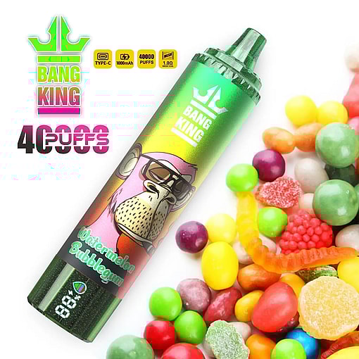 Green and multicolored disposable vape pen labeled Bang King Watermelon Bubblegum placed near a pile of colorful assorted candies and gummies